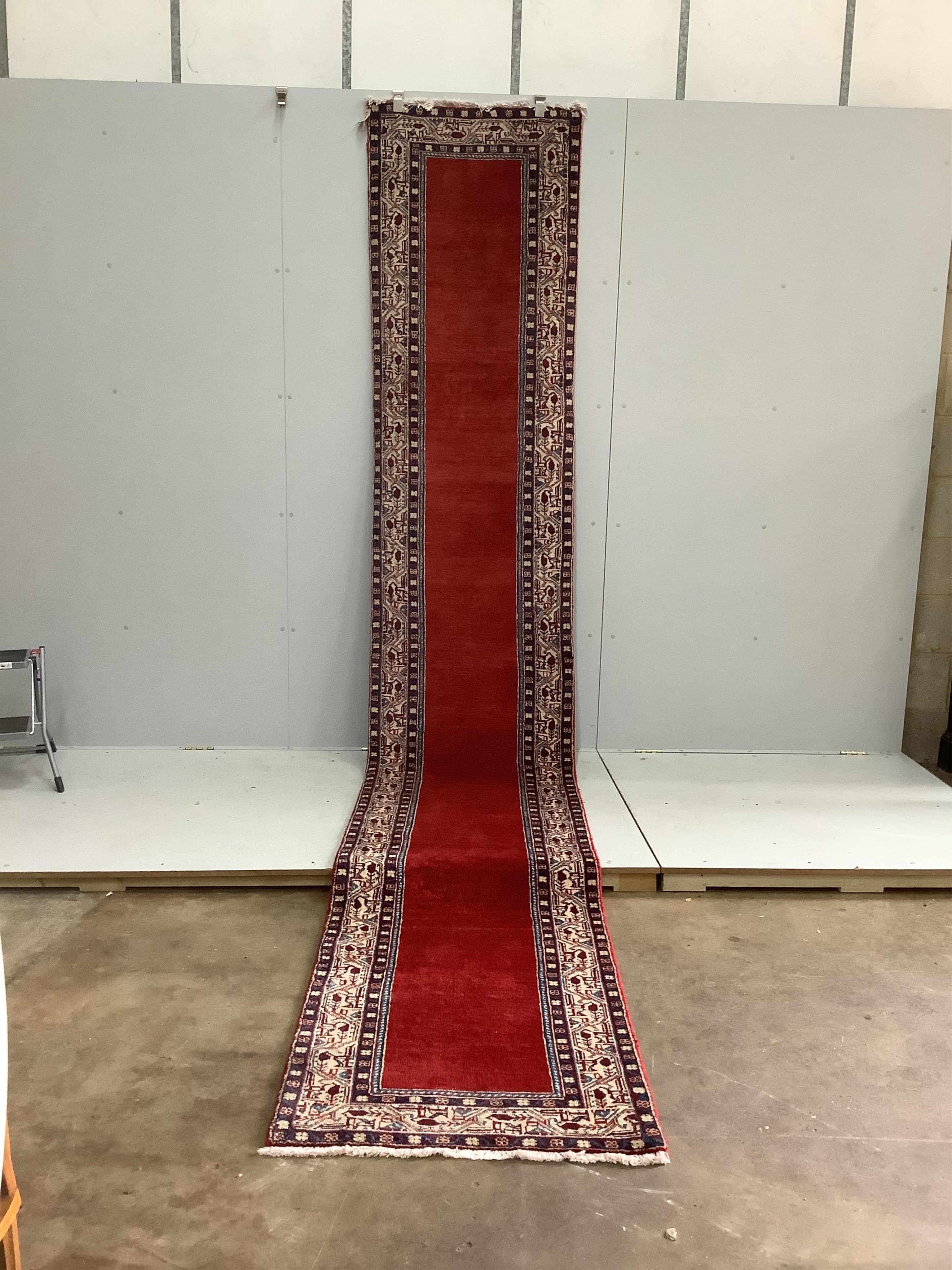 An Araak red ground runner, 440 x 76cm. Condition - fair to good